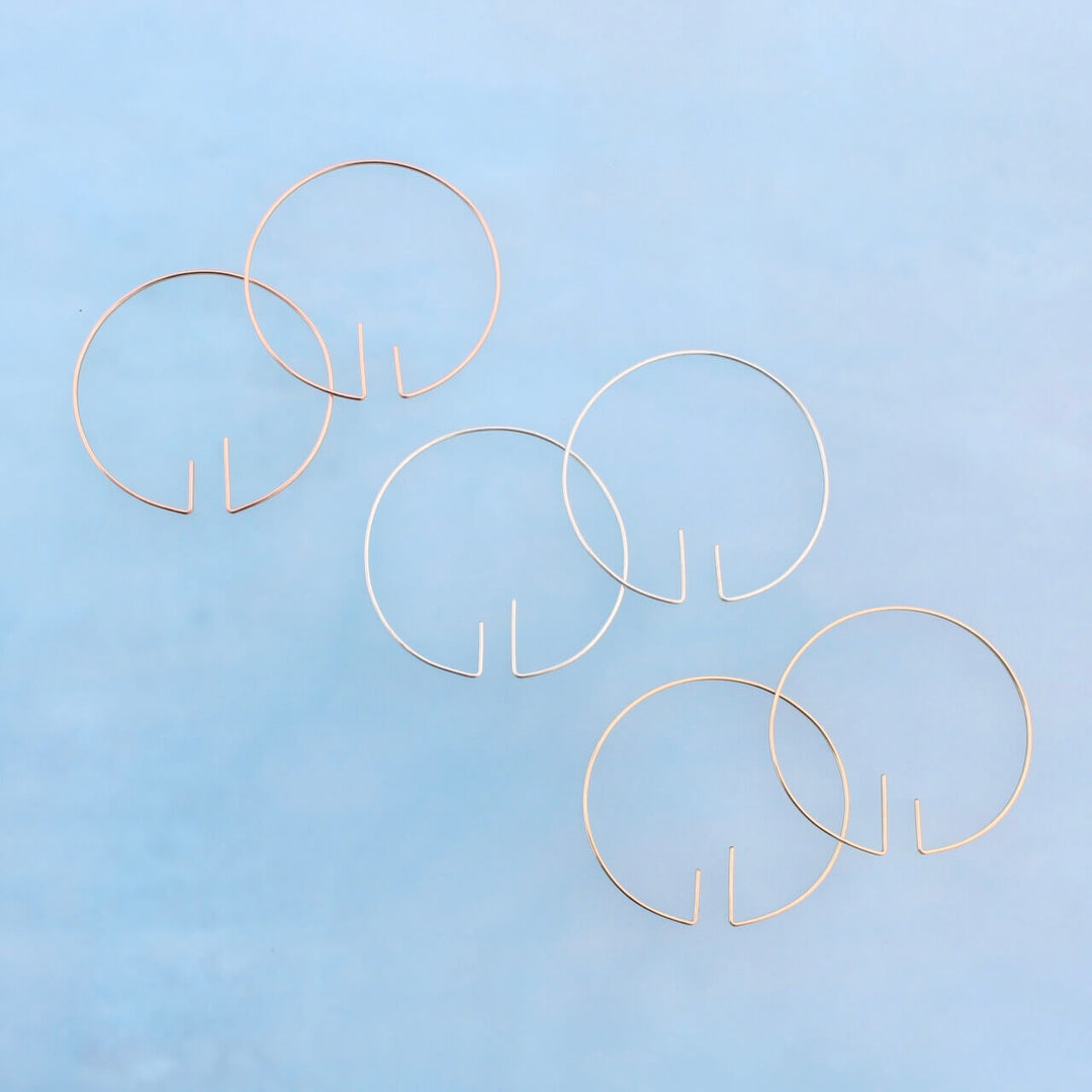 Unique open hoops in recycled sterling silver, 14k gold and rose gold. Minimal and modern earrings. 