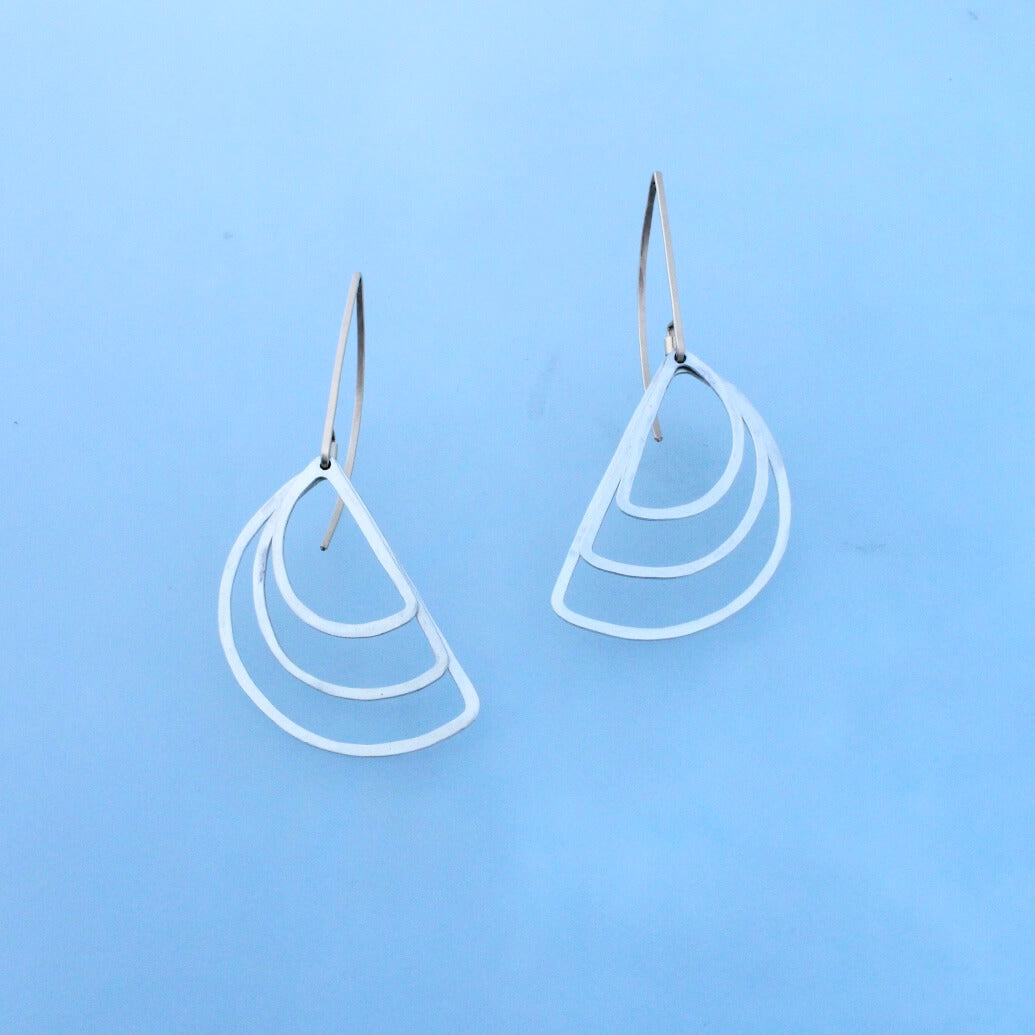 Silver and gold minimal dangles. One inch long modern gold ear wires with  three concentric silver semicircles.
