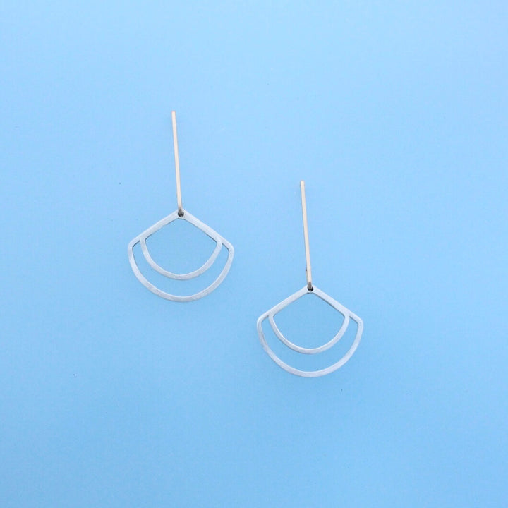 Modern 14k gold ear wires with two geometric dangles in the shape of fans.