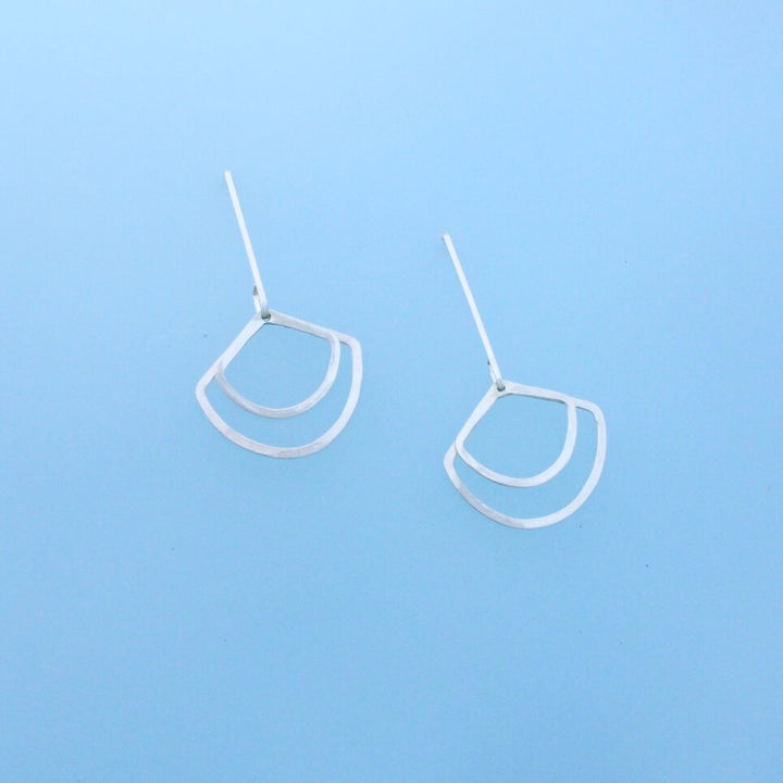 Minimalist dangles one inch earwires with two hanging geometric dangles in the shape of fans.