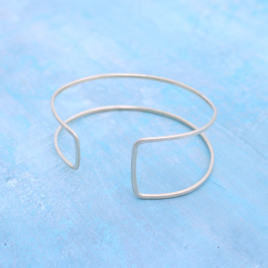 adjustable wire cuff bracelet in sterling silver with an asymmetrical rectangle design