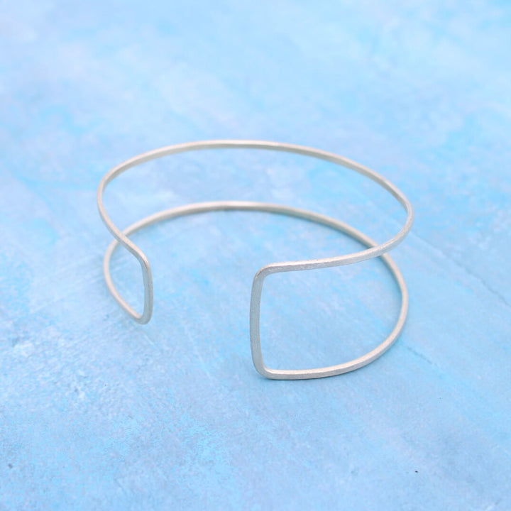 adjustable wire cuff bracelet in sterling silver with an asymmetrical rectangle design